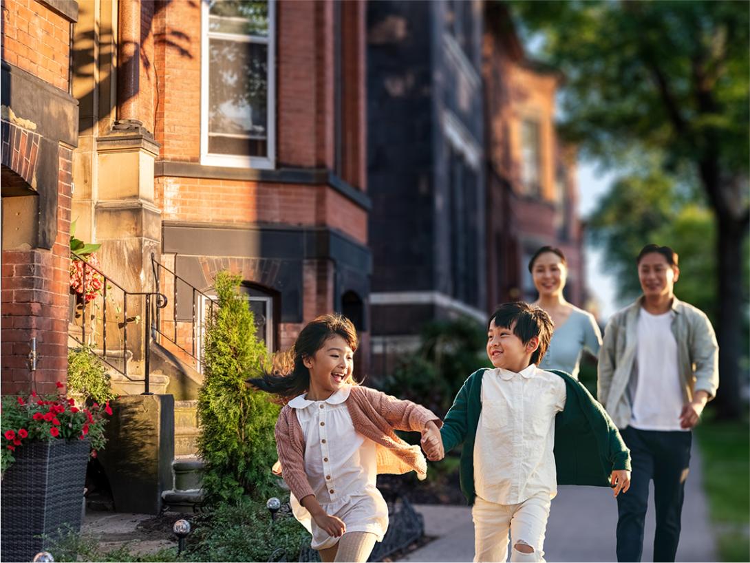 A happy family walking down the sidewalk