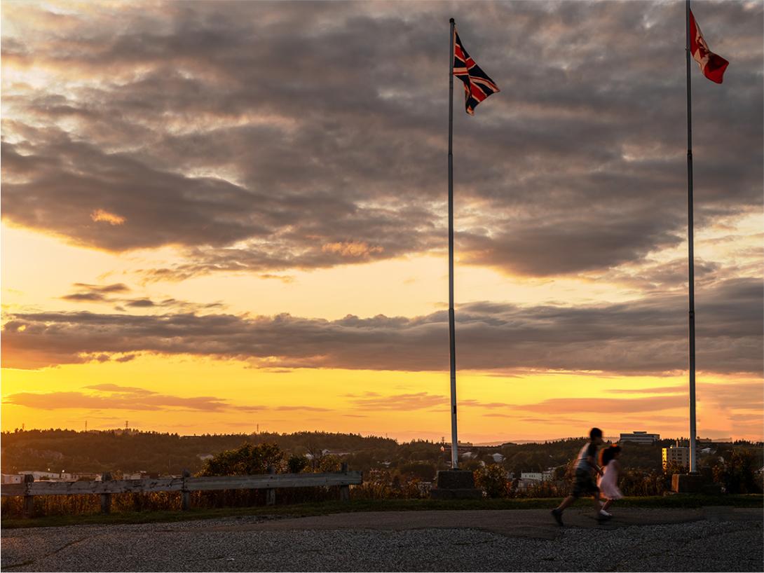 A sunset view with a Canadian and a UK flag visible