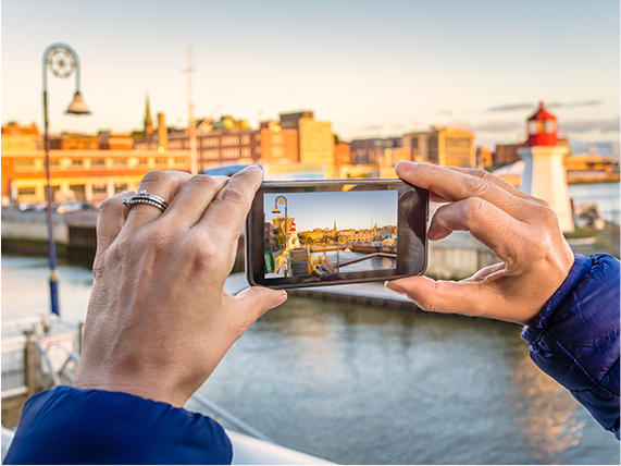 A person taking a picture of the skyline with their phone