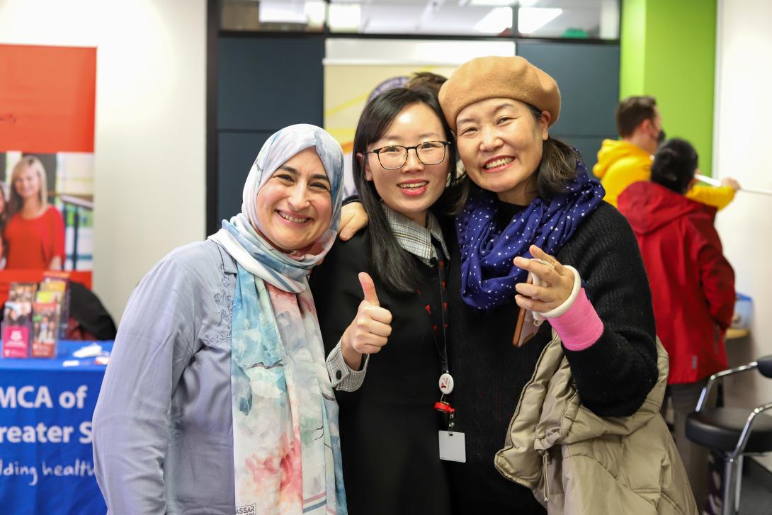 Image of three people smiling