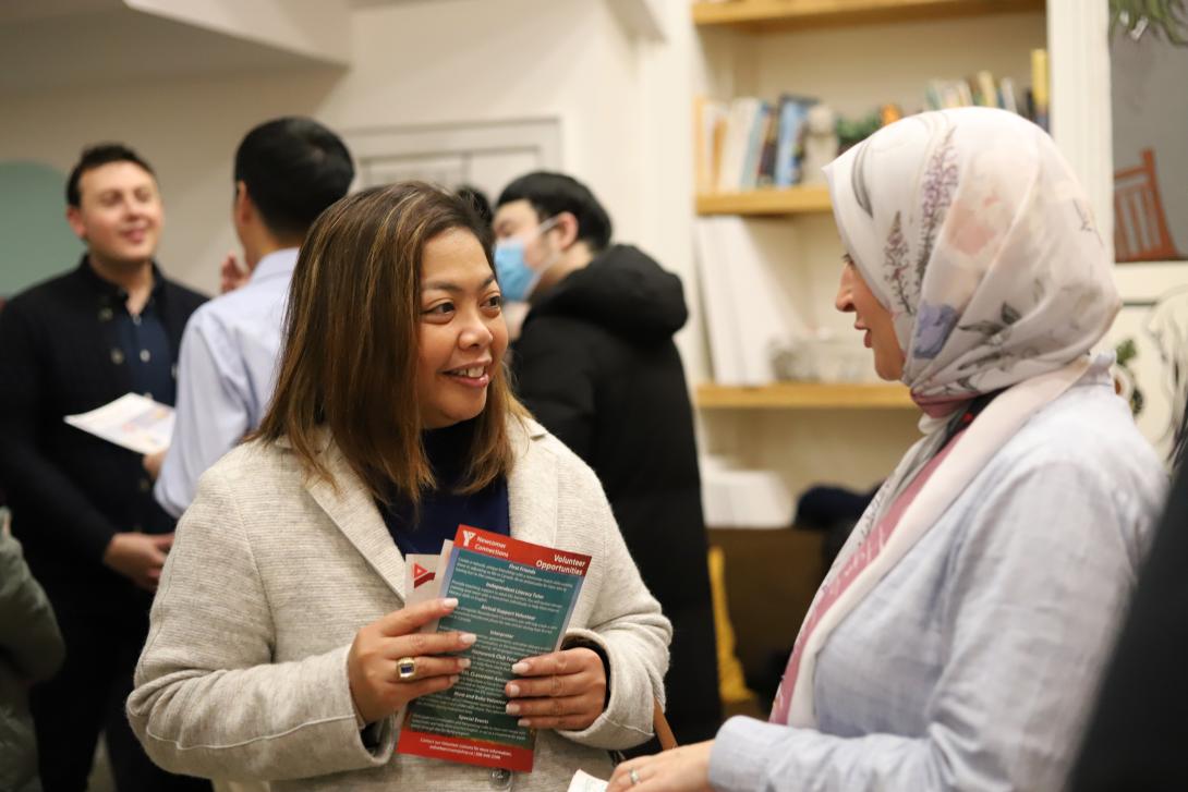 Two people speaking and smiling