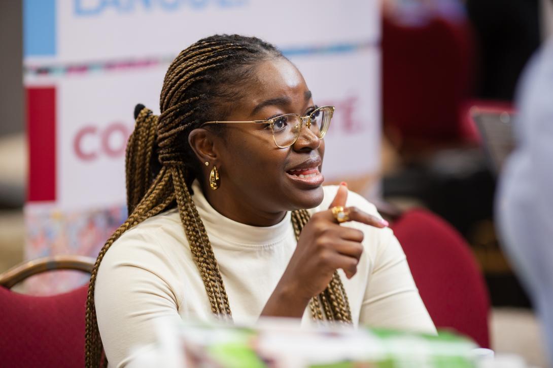 Person sitting at a table speaking