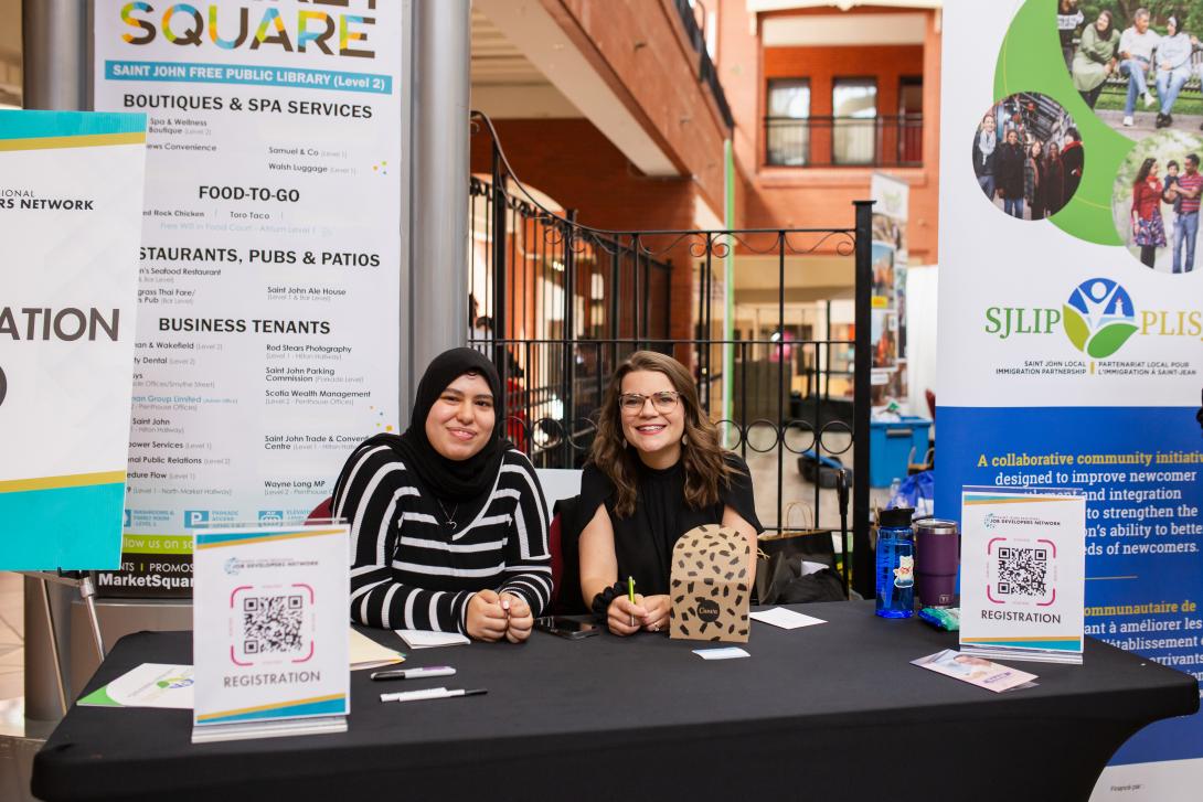 Two people at a booth 