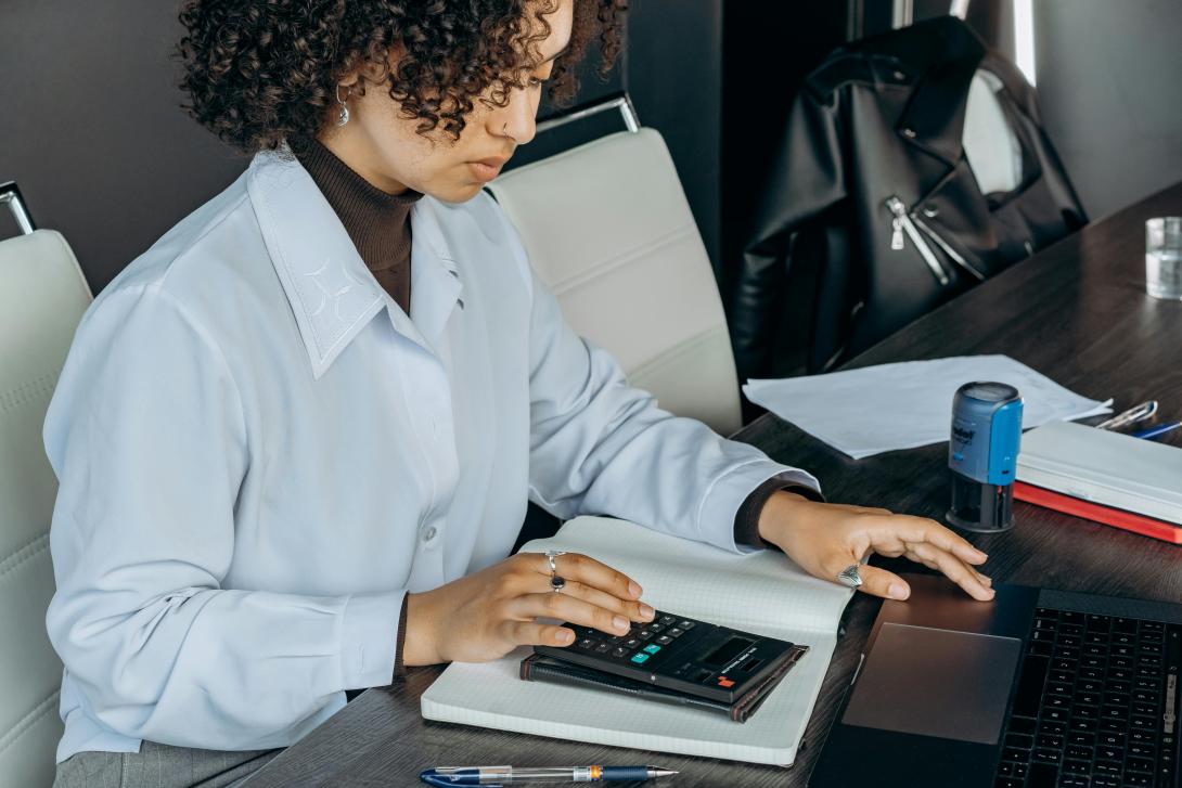 Someone using a calculator to file taxes